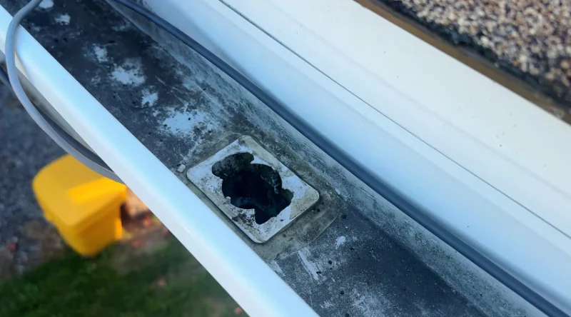 Downspout outlet with debris blocking water flow in Anderson, SC